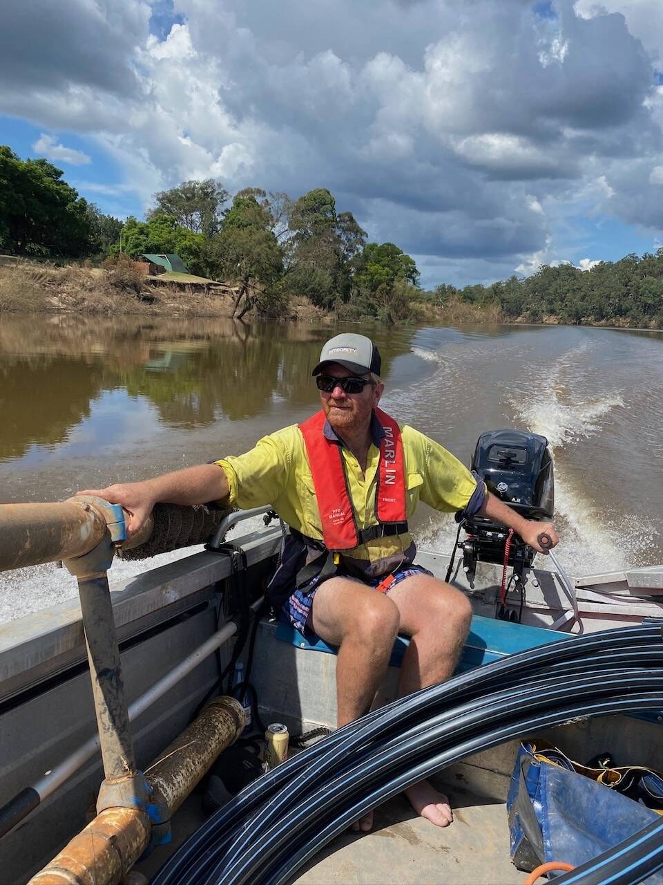 Running poly pipe out on the river from a tinny