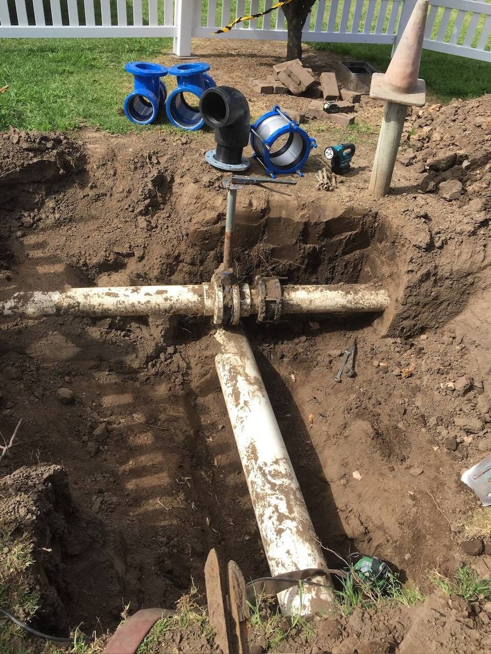 Irrigation valves exposed in a dug hole